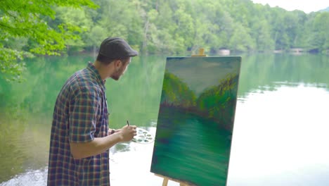 Talented-painter-who-paints-a-lake-landscape.